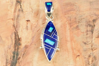 Genuine Blue Lapis inlaid between ribbons of Sterling Silver. Beautiful Fire and Ice Lab Opal accents. Precision inlay on the bale and pendant. Free 18